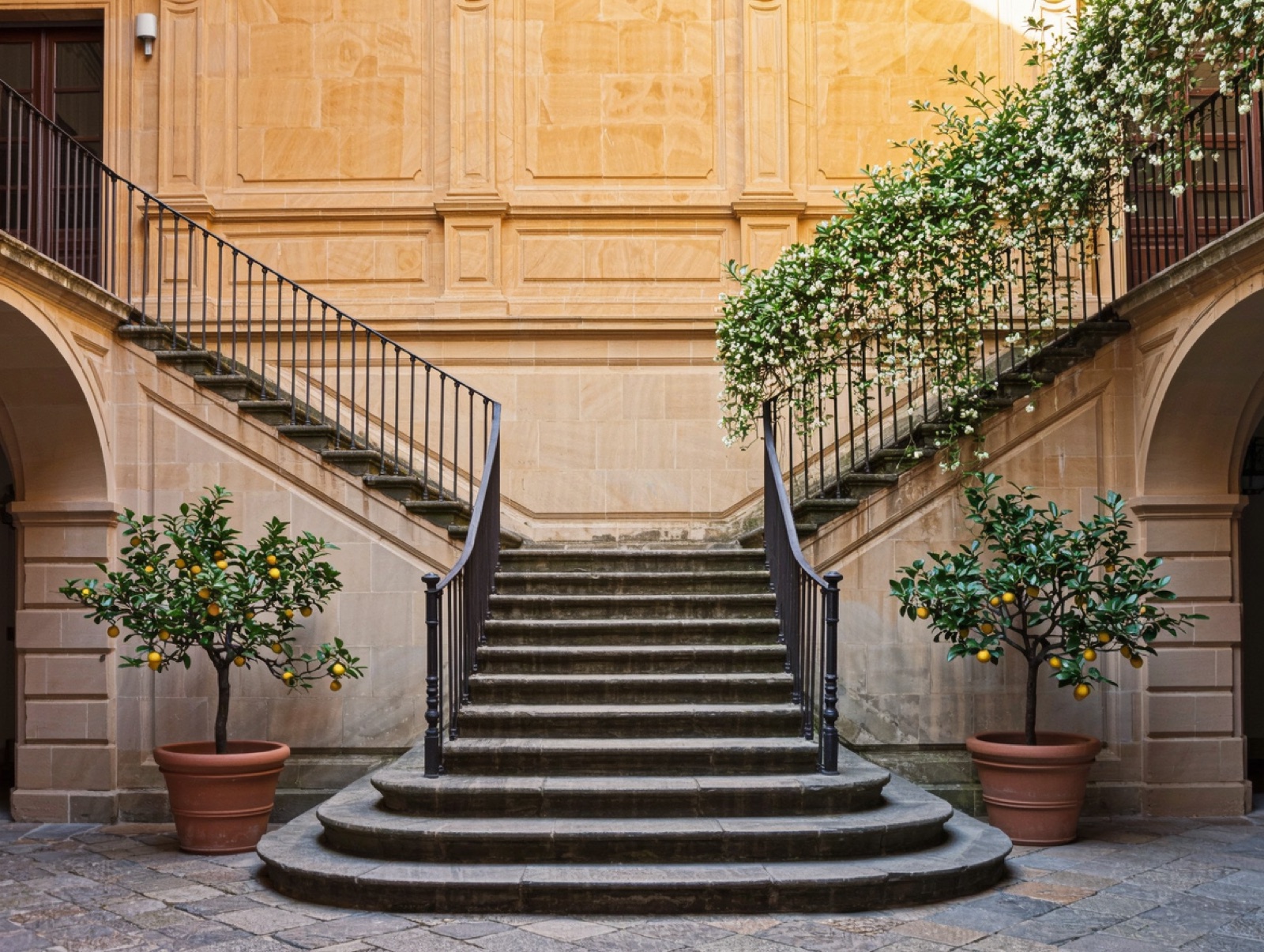 The inner courtyard with its stone staircase and potted plants