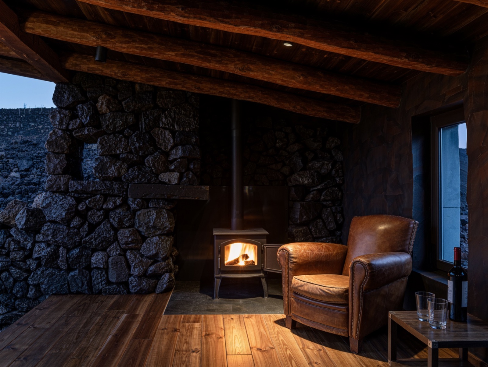 The lava-stone house with the vineyard and Etna behind it